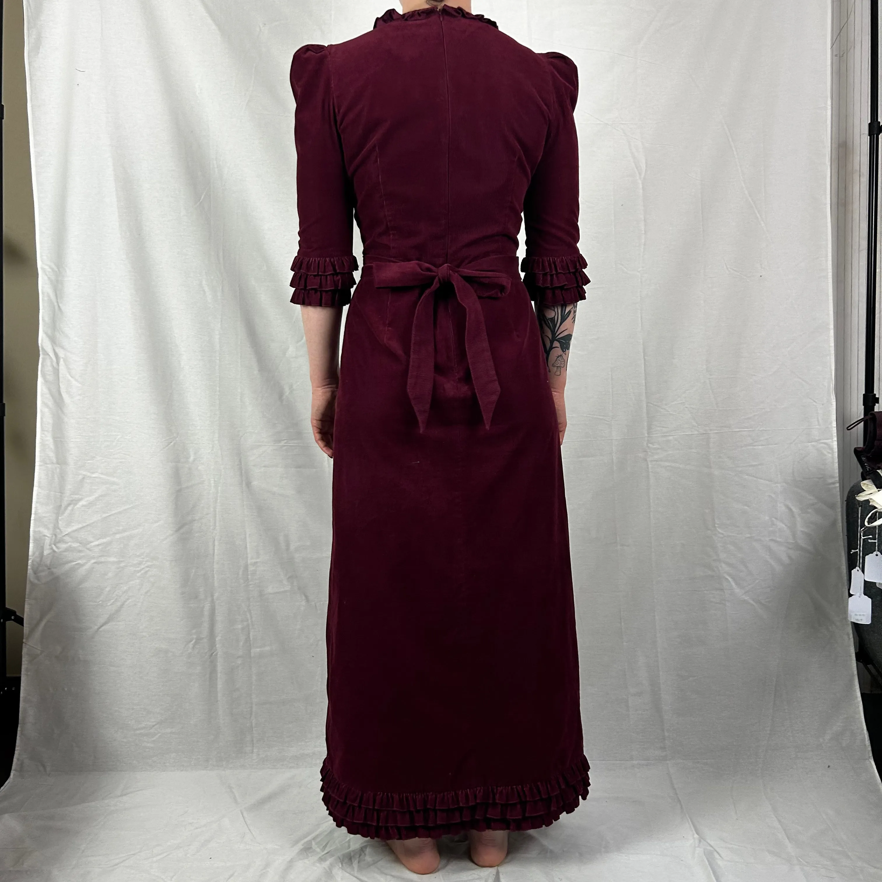 Here’s an optimized title for the e-commerce product:

The Vampires Wife Burgundy Needlecord Maxi Dress - Size Small, Elegant Vintage Style